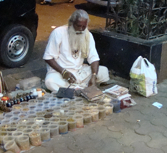 Back on the street below, this man sells Ayurvedic medicines and is an acknowledged expert in his field. No rent keeps his home made preparations affordable to many. He has had his practice for 50 years.