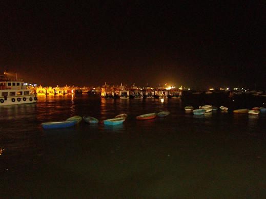Fishing boats and local ferries are moored for the evening along the Apollo Bunder waterfront. 
