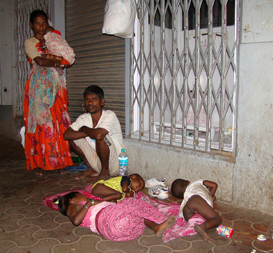 Others are not so fortunate. This man has just arrived from Calcutta and lives on the pavement with his wife and four children. He makes a living hassling tourists to buy flowers from a shop he doesn’t own. If he progresses well and is good at persuading customers to follow him, he may get taken on as a permanent, yet commission only employee by a decent tailor or jewelers. That may be enough to get his children, after years of hard work, into college. Both he and his wife spoke fluent English, so he has a chance to move up. 